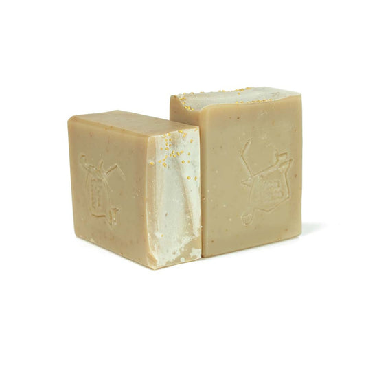 Almond Artisan Soap bar in beige with golden speckles, embossed Don Gato logo, almond and cherry scent.