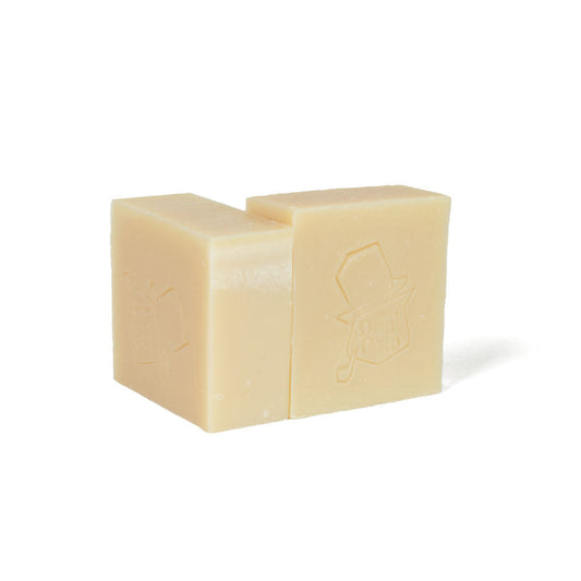 Mystic Veil artisan soap by Don Gato Soap Co., two creamy off-white bars with an embossed cat-in-top-hat stamp, in bright light on a white background.